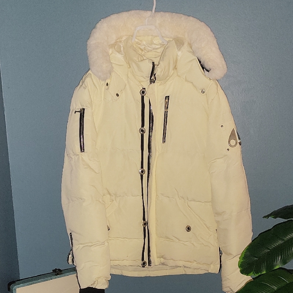 Moose Knuckles Cream Down Jacket with Embroidered Detail.